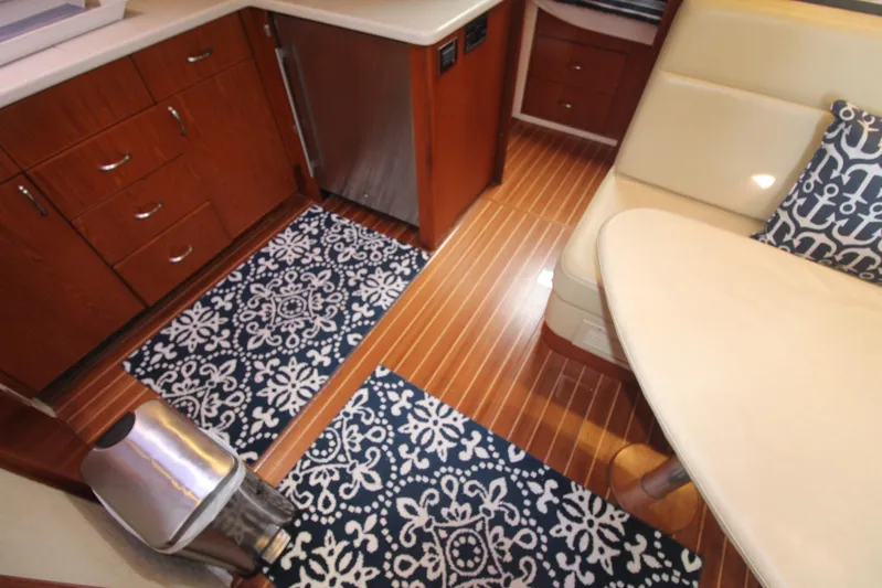 Pescador Yacht Photos Pics Interior of 2013 Cabo 40 Hardtop Express with wood flooring and elegant seating area.