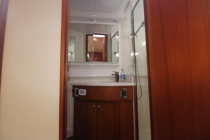 Pescador Yacht Photos Pics 2013 Cabo 40 Hardtop Express bathroom with wooden cabinetry and modern fixtures.