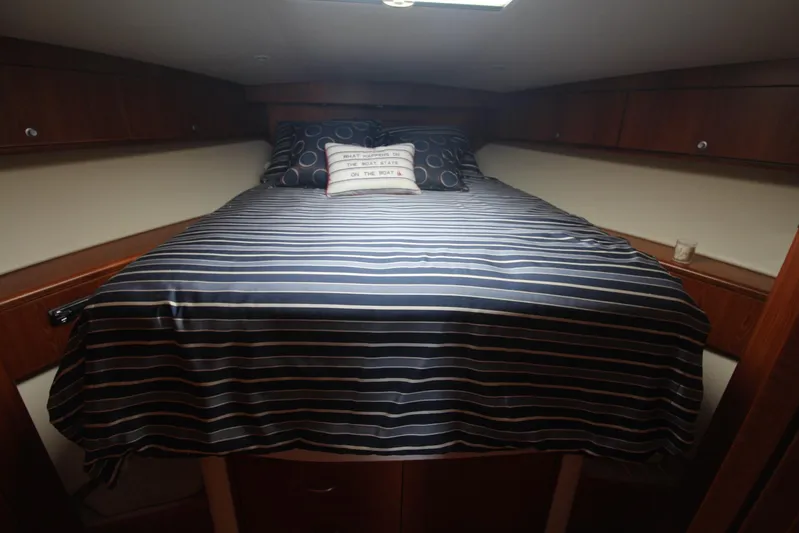 Pescador Yacht Photos Pics Cozy cabin interior of 2013 Cabo 40 Hardtop Express with striped bedding.