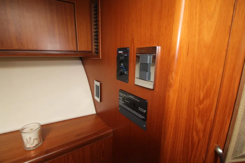 Pescador Yacht Photos Pics Interior of 2013 Cabo 40 Hardtop Express with wooden paneling and control panels.
