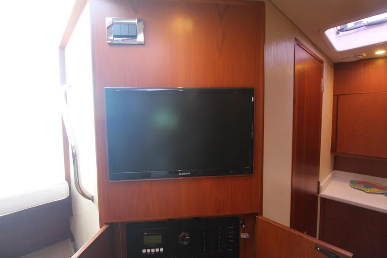 Pescador Yacht Photos Pics Interior of 2013 Cabo 40 Hardtop Express with mounted TV and wooden cabinetry.
