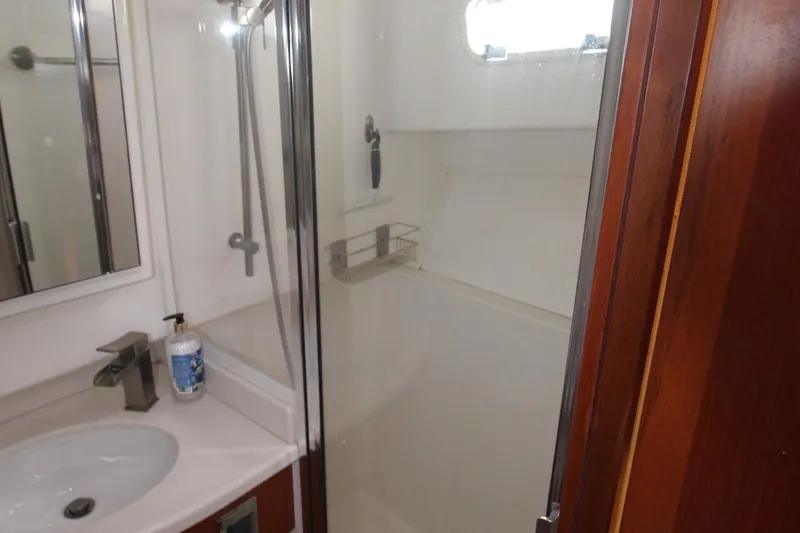 Pescador Yacht Photos Pics 2013 Cabo 40 Hardtop Express bathroom with shower, sink, and wooden accents.