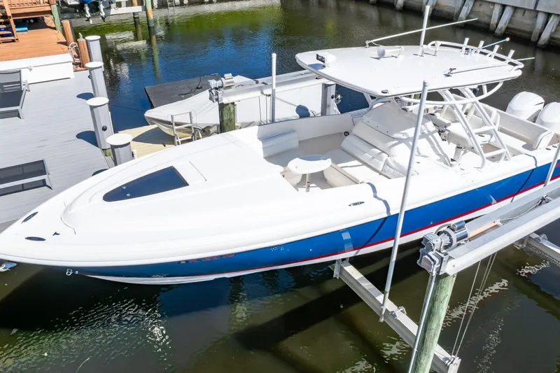  Yacht Photos Pics 2015 Intrepid 327 Cuddy boat docked, featuring sleek design and spacious deck.