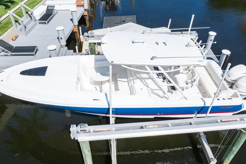  Yacht Photos Pics 2015 Intrepid 327 Cuddy boat docked on a lift, aerial view.