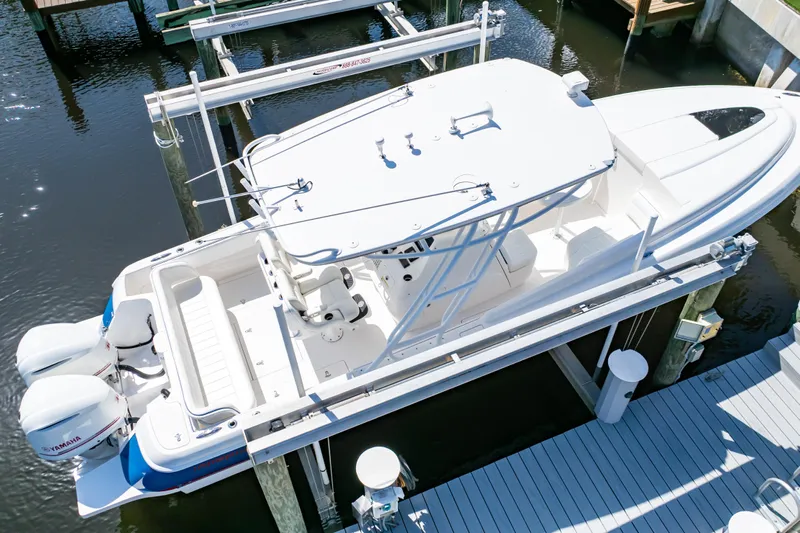  Yacht Photos Pics 2015 Intrepid 327 Cuddy boat docked with twin Yamaha engines, aerial view.