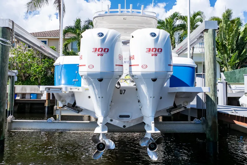  Yacht Photos Pics 2015 Intrepid 327 Cuddy with twin Yamaha 300 V6 engines docked by palm trees.