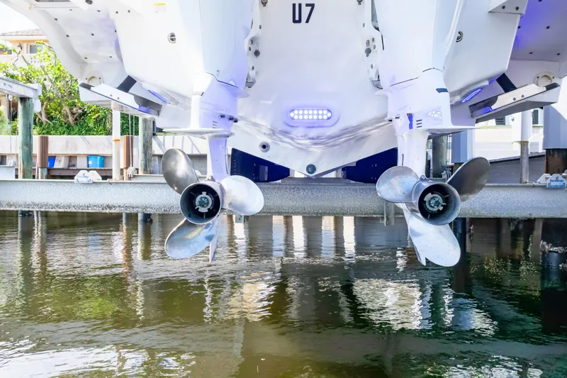  Yacht Photos Pics 2015 Intrepid 327 Cuddy boat propellers above water on a lift.