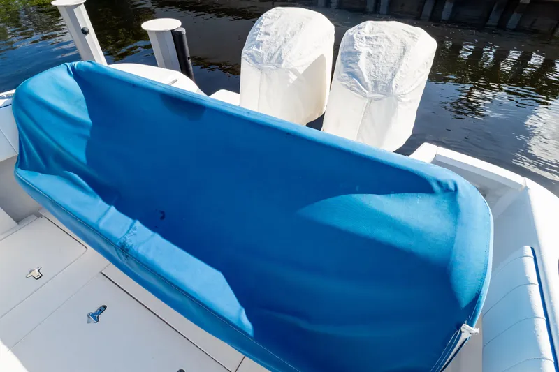  Yacht Photos Pics 2015 Intrepid 327 Cuddy boat with blue cover and twin engines.