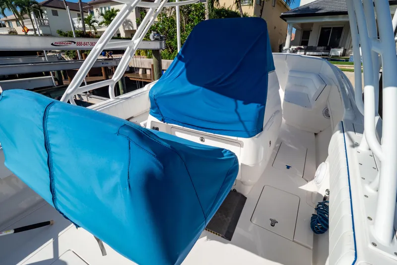  Yacht Photos Pics 2015 Intrepid 327 Cuddy boat interior with blue seat covers and white deck.