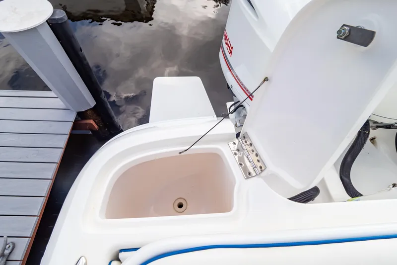  Yacht Photos Pics Open storage compartment on a 2015 Intrepid 327 Cuddy boat near a dock.