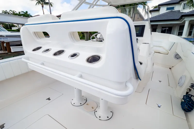  Yacht Photos Pics 2015 Intrepid 327 Cuddy boat interior with rod holders and seating area.