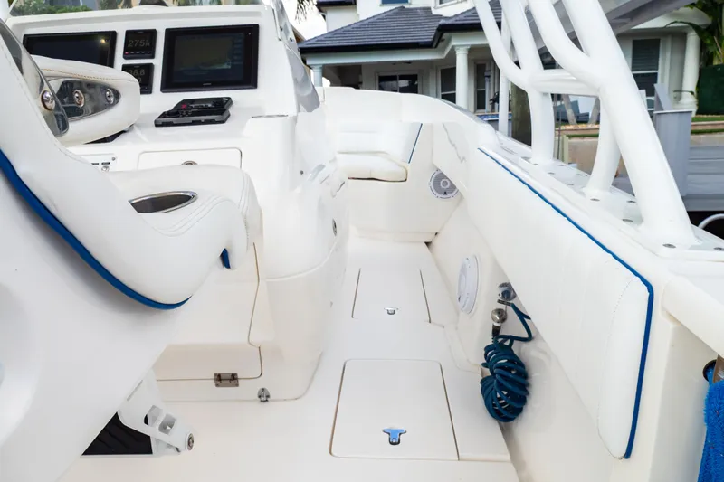  Yacht Photos Pics 2015 Intrepid 327 Cuddy interior with white seating and modern dashboard controls.