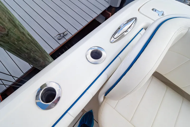  Yacht Photos Pics 2015 Intrepid 327 Cuddy boat interior with white seating and stainless steel fixtures.