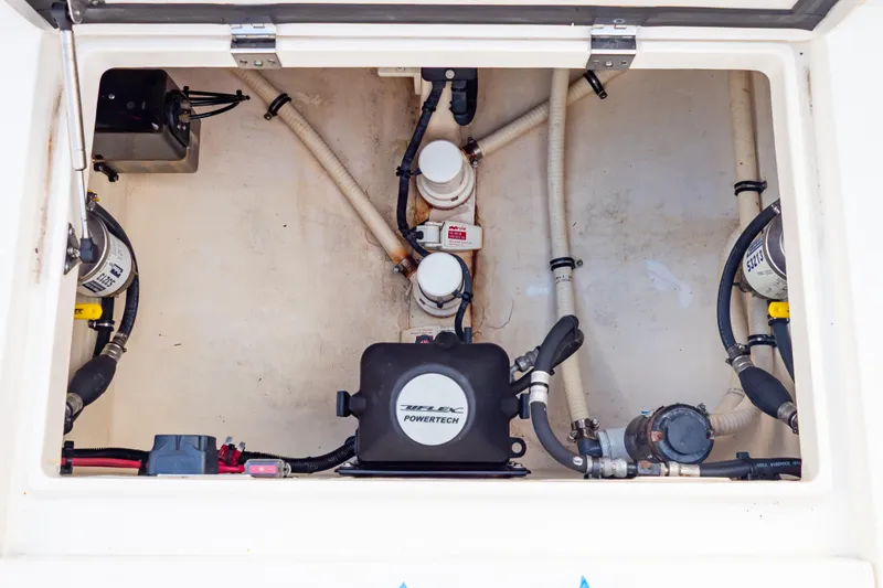  Yacht Photos Pics Engine compartment of a 2015 Intrepid 327 Cuddy boat, showcasing mechanical components.