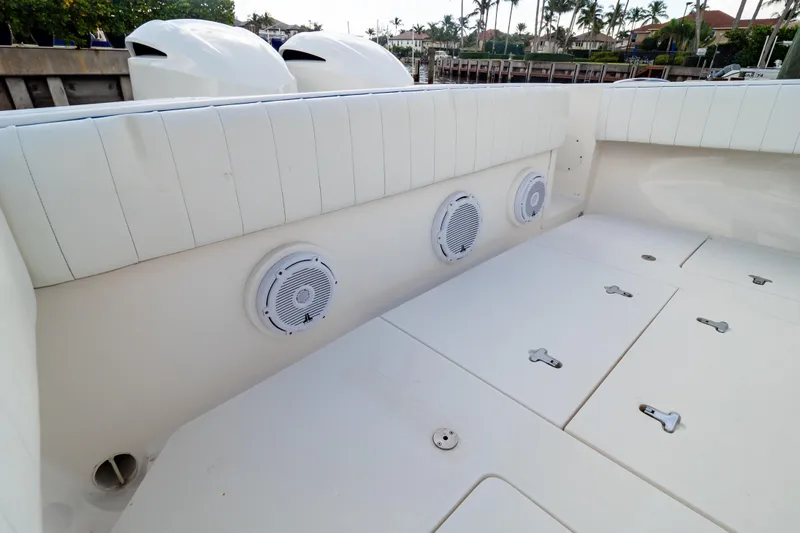  Yacht Photos Pics 2015 Intrepid 327 Cuddy boat interior with white seating and built-in speakers.