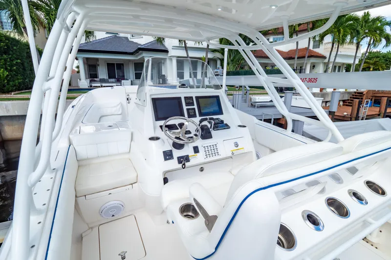  Yacht Photos Pics 2015 Intrepid 327 Cuddy boat interior with modern dashboard and seating.