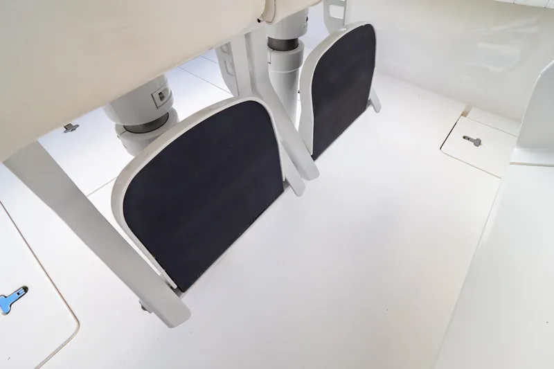  Yacht Photos Pics 2015 Intrepid 327 Cuddy boat interior with footrests and clean white deck.