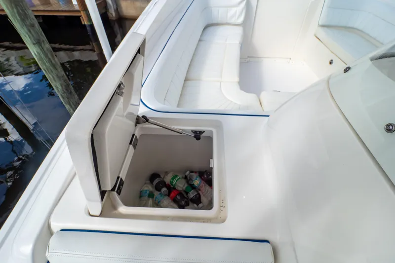  Yacht Photos Pics 2015 Intrepid 327 Cuddy boat with open cooler and white seating.