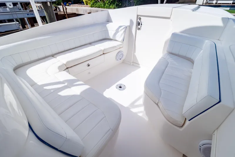 Yacht Photos Pics 2015 Intrepid 327 Cuddy boat interior with white cushioned seating.