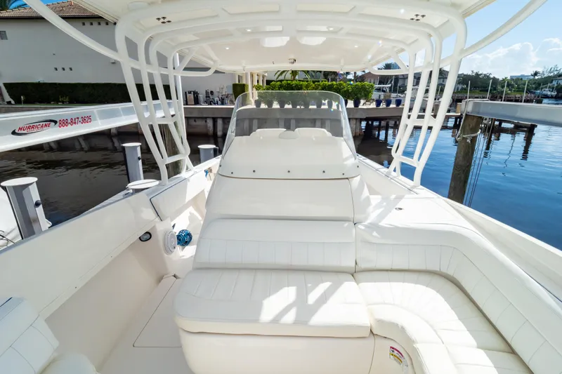  Yacht Photos Pics 2015 Intrepid 327 Cuddy boat interior with white seating and waterfront view.