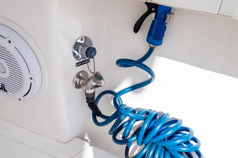  Yacht Photos Pics 2015 Intrepid 327 Cuddy boat with blue coiled hose and speaker detail.