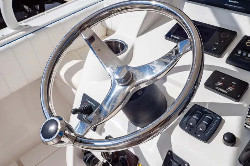  Yacht Photos Pics Steering wheel and controls of a 2015 Intrepid 327 Cuddy boat.