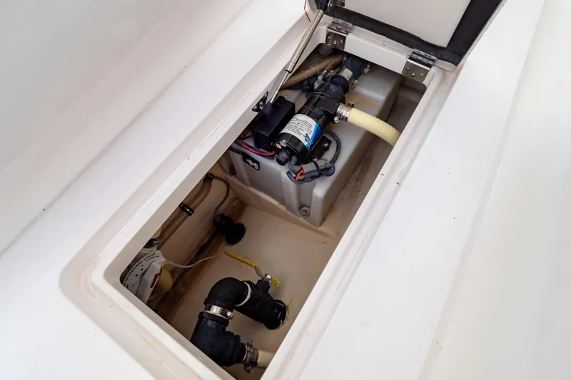  Yacht Photos Pics 2015 Intrepid 327 Cuddy boat compartment with pump and plumbing system.
