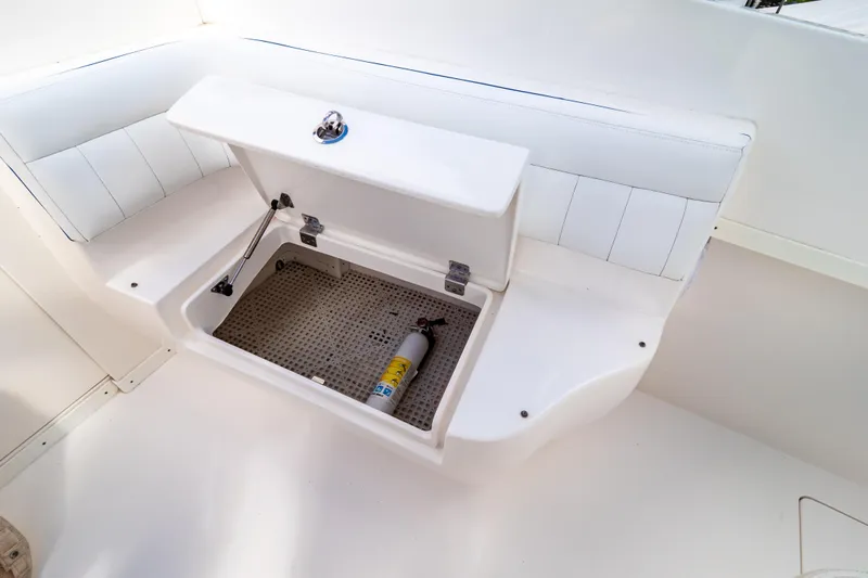  Yacht Photos Pics Open storage compartment on 2015 Intrepid 327 Cuddy boat with fire extinguisher inside.