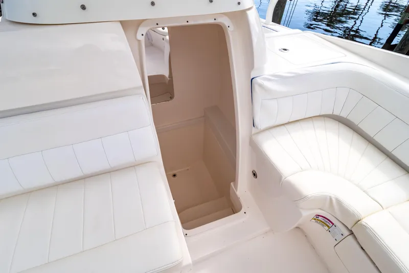  Yacht Photos Pics 2015 Intrepid 327 Cuddy interior with white seating and open cabin entrance.