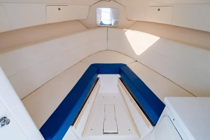  Yacht Photos Pics Interior of 2015 Intrepid 327 Cuddy boat with blue and white seating.