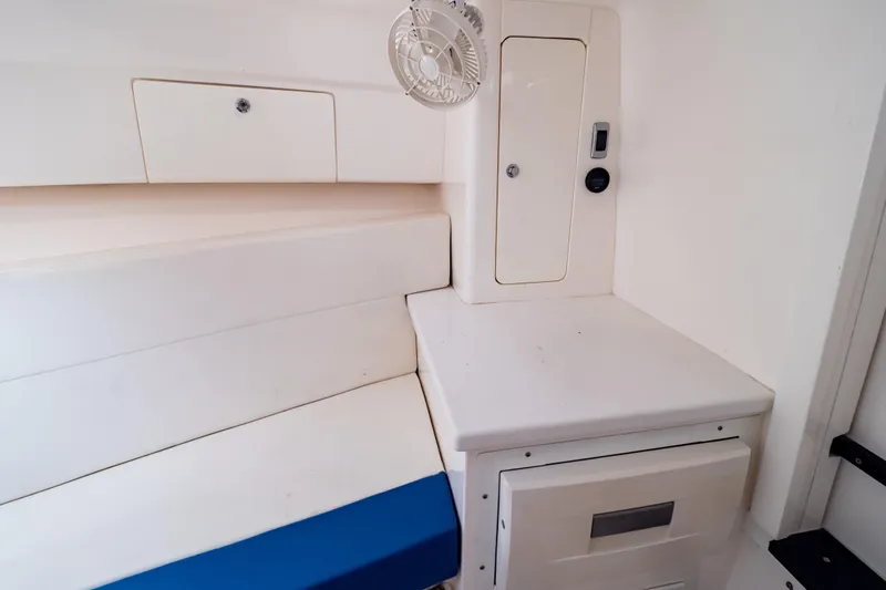  Yacht Photos Pics Interior of a 2015 Intrepid 327 Cuddy boat with seating and storage compartments.