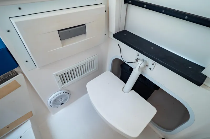  Yacht Photos Pics Interior view of a 2015 Intrepid 327 Cuddy boat, featuring seating and storage compartments.