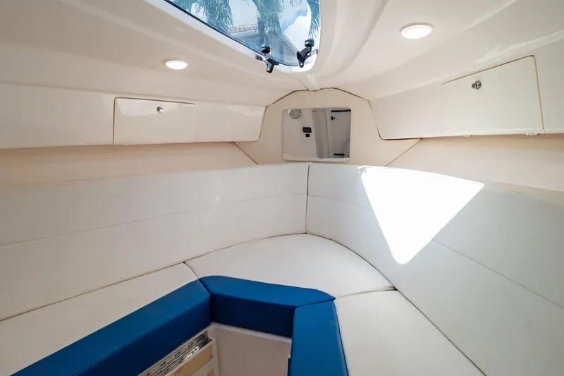  Yacht Photos Pics 2015 Intrepid 327 Cuddy interior with white seating and overhead hatch.