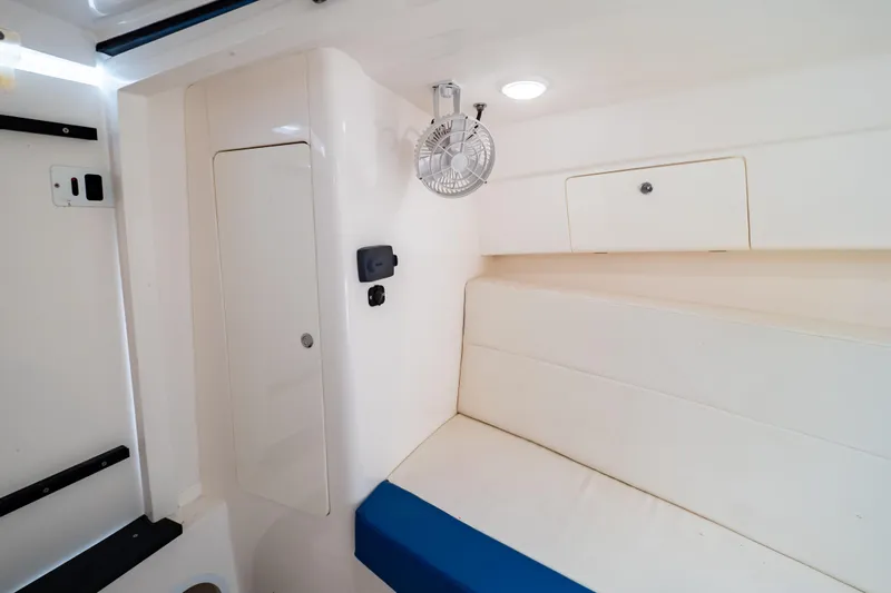  Yacht Photos Pics 2015 Intrepid 327 Cuddy interior with white seating and storage compartments.