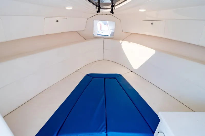  Yacht Photos Pics 2015 Intrepid 327 Cuddy interior with blue and white seating, modern design.