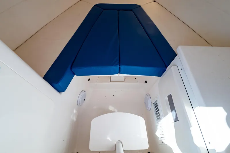 Yacht Photos Pics 2015 Intrepid 327 Cuddy interior with blue cushions and white cabin features.