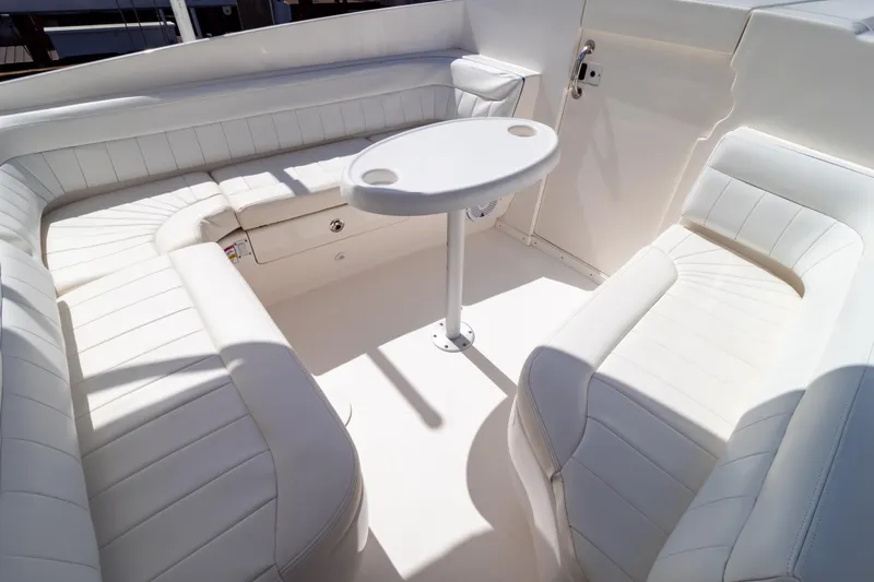  Yacht Photos Pics 2015 Intrepid 327 Cuddy boat interior with white seating and a small table.