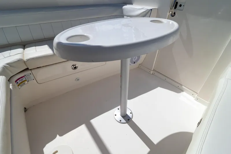  Yacht Photos Pics 2015 Intrepid 327 Cuddy interior with white seating and oval table.