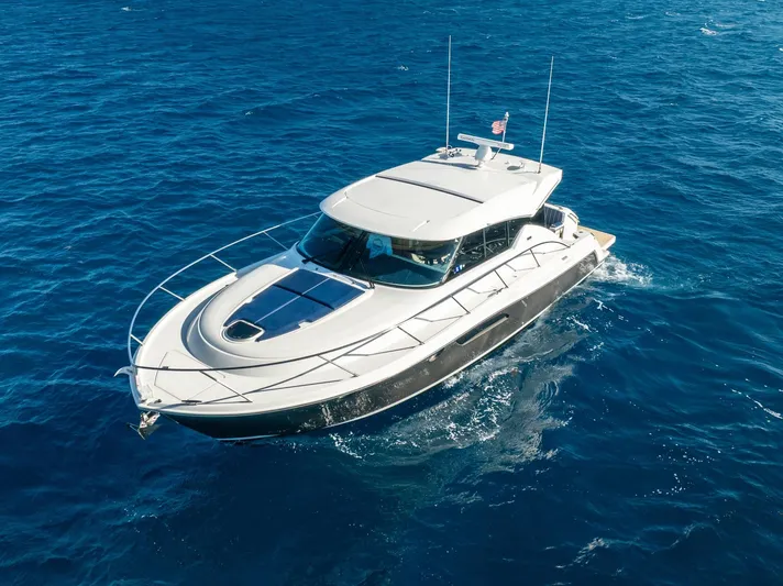 Down Time Yacht Photos Pics 2015 Tiara Yachts C44 Coupe cruising on open blue sea.