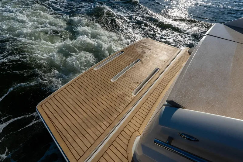 Down Time Yacht Photos Pics Teak swim platform on 2015 Tiara Yachts C44 Coupe, with ocean waves.