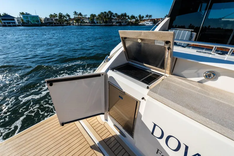 Down Time Yacht Photos Pics 2015 Tiara Yachts C44 Coupe with open grill on deck, cruising on sunny waters.