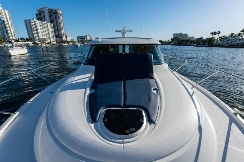 Down Time Yacht Photos Pics 2015 Tiara Yachts C44 Coupe on water, city skyline in background.