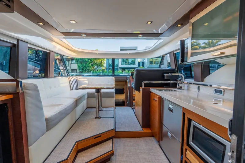 Down Time Yacht Photos Pics Luxurious interior of 2015 Tiara Yachts C44 Coupe with modern kitchen and seating area.