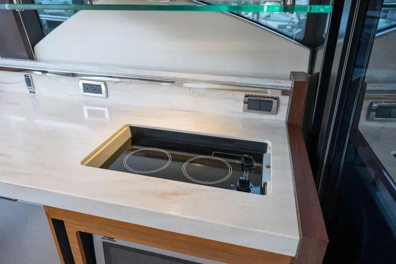 Down Time Yacht Photos Pics Modern kitchen area in 2015 Tiara Yachts C44 Coupe with built-in stovetop.