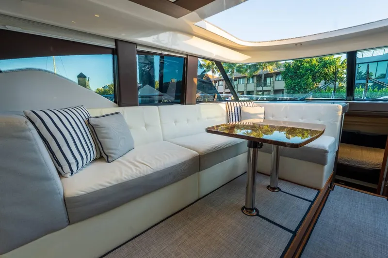 Down Time Yacht Photos Pics Luxurious interior of 2015 Tiara Yachts C44 Coupe with plush seating and elegant table.