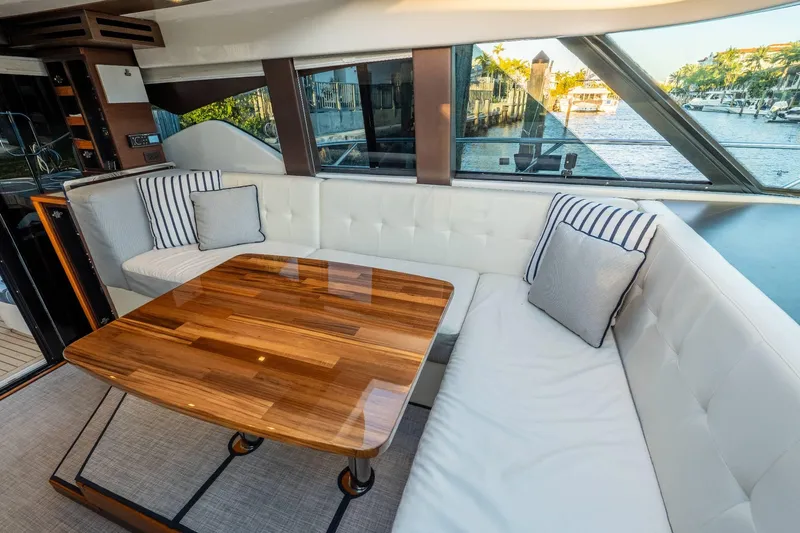Down Time Yacht Photos Pics Luxurious interior of 2015 Tiara Yachts C44 Coupe with elegant seating and wooden table.