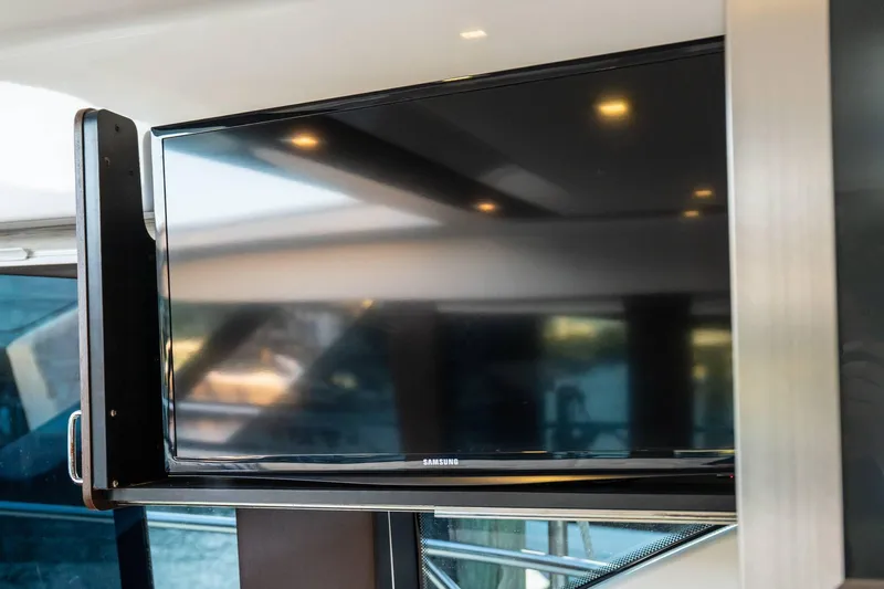Down Time Yacht Photos Pics Flat-screen TV inside 2015 Tiara Yachts C44 Coupe, showcasing modern interior design.