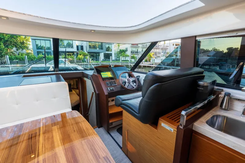 Down Time Yacht Photos Pics Interior of 2015 Tiara Yachts C44 Coupe, featuring helm, seating, and kitchenette.