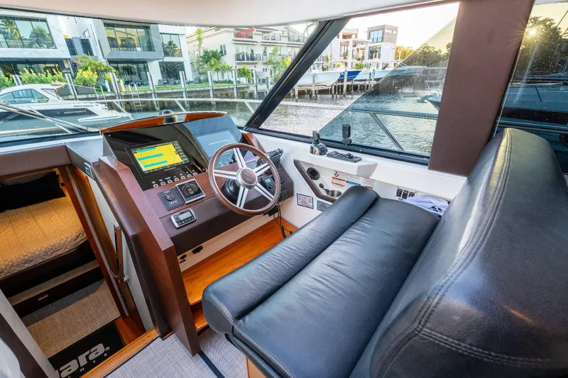 Down Time Yacht Photos Pics 2015 Tiara Yachts C44 Coupe helm with leather seating and modern navigation controls.