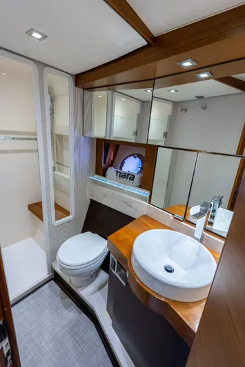 Down Time Yacht Photos Pics Luxurious bathroom in 2015 Tiara Yachts C44 Coupe with modern fixtures and elegant wood accents.
